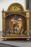 Henri Valentini 1955
Crèche en liège, santons cigales 30 x 23 x 38 cm. <br>
« Peut-être le chef d'œuvre d'Henri Valentini qui a librement combiné ici les principes de la crèche à voûte et de la crèche en liège On retrouve une représentation du « Père éternel » sur le haut de l’œuvre Les santons ne sont pas fixés à la crèche. Seuls les bustes de l’âne et du bœuf sont représentés. Les santons sont assez reconnaissables, notamment la femme à la tresse d’ail, la femme à la fougasse et à la poule noire, un berger, le couple de vieux, Saint Joseph, la Sainte Vierge et l'Enfant Jésus »
Régis Bertrand